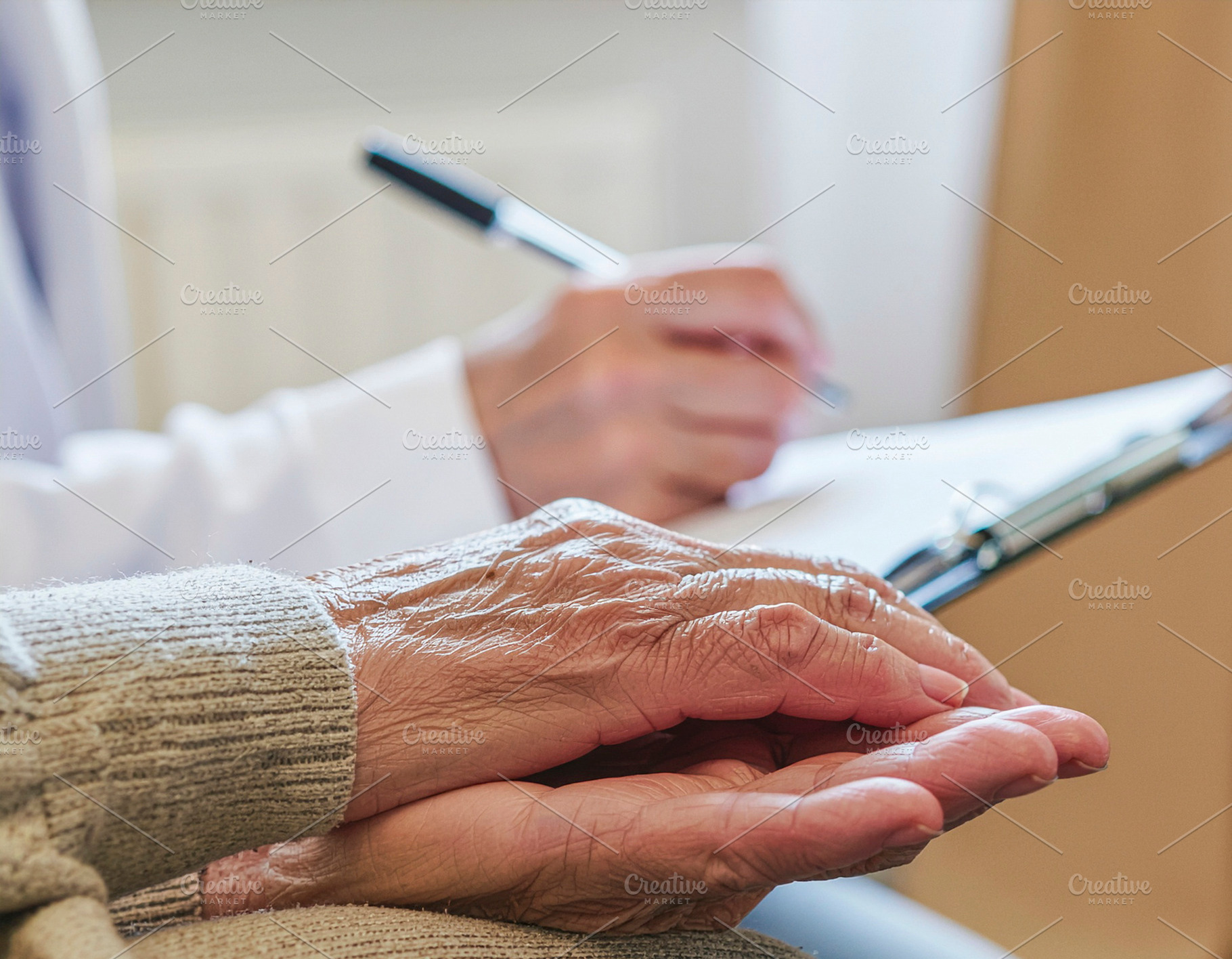 Geriatric consultation hands and notes closeup, a Photo by DanFLCreativo