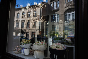 Elegant flower arrangement display in a storefront with reflection. Flowers ins, a Photo by AS photostudio