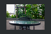 Outdoor Cafe Table and Wicker Chair, a Background Photo by AMMi (Thumbnail 2 of 3)