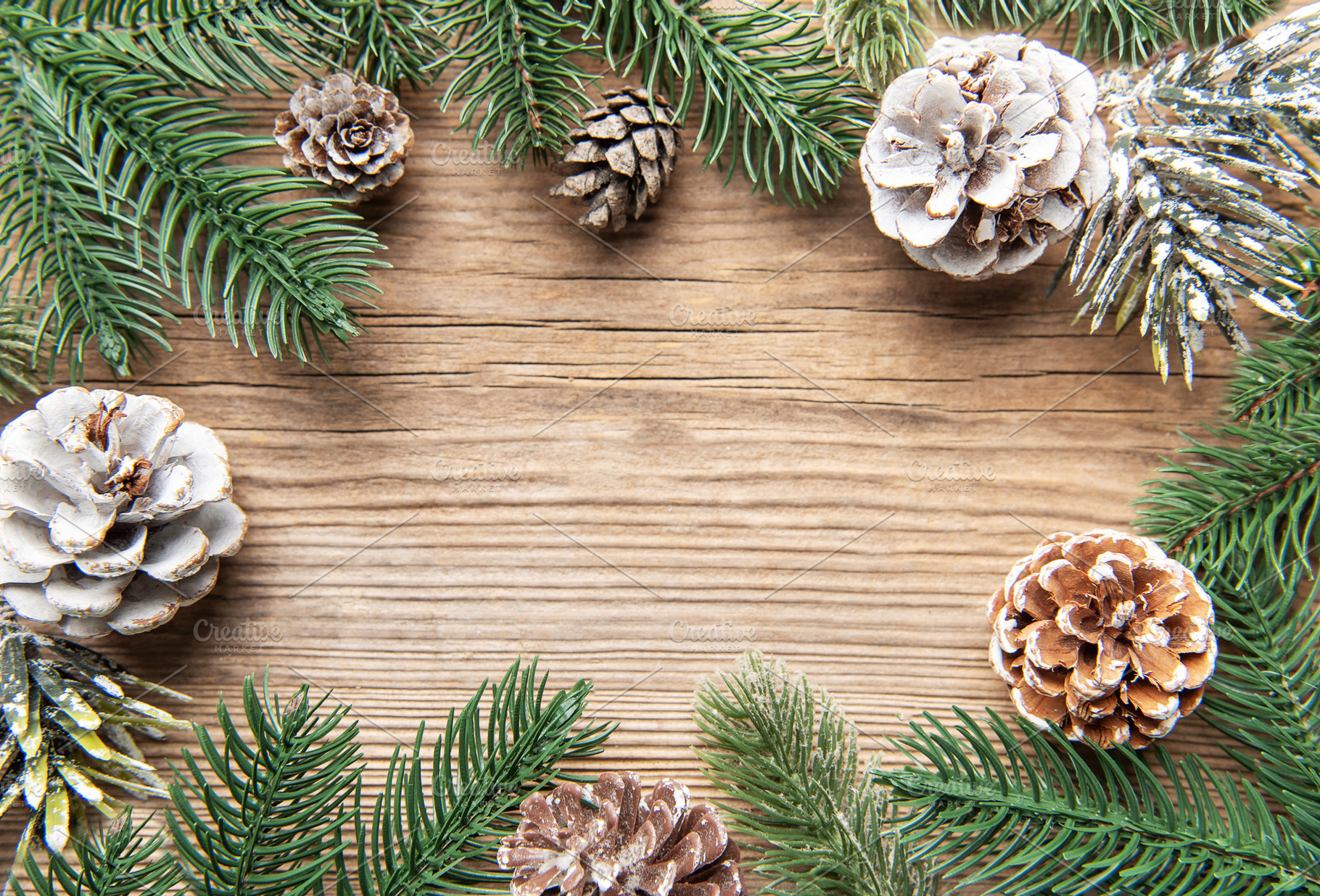 Christmas pine cones and fir branches on wooden background, a Holiday Photo by Olena Rudo