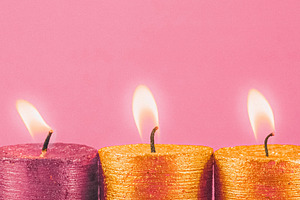 Four shimmering glitter candles casting a cozy light on a gentle, a Photo by Studio ANNA