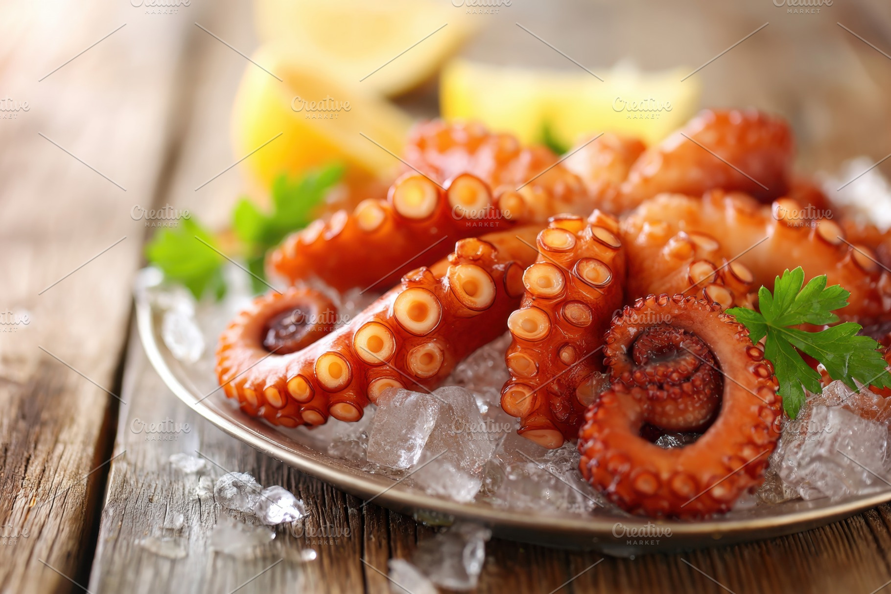 Fresh octopus on ice with lemon and parsley, a Food & Drink Photo by AlyaAnd