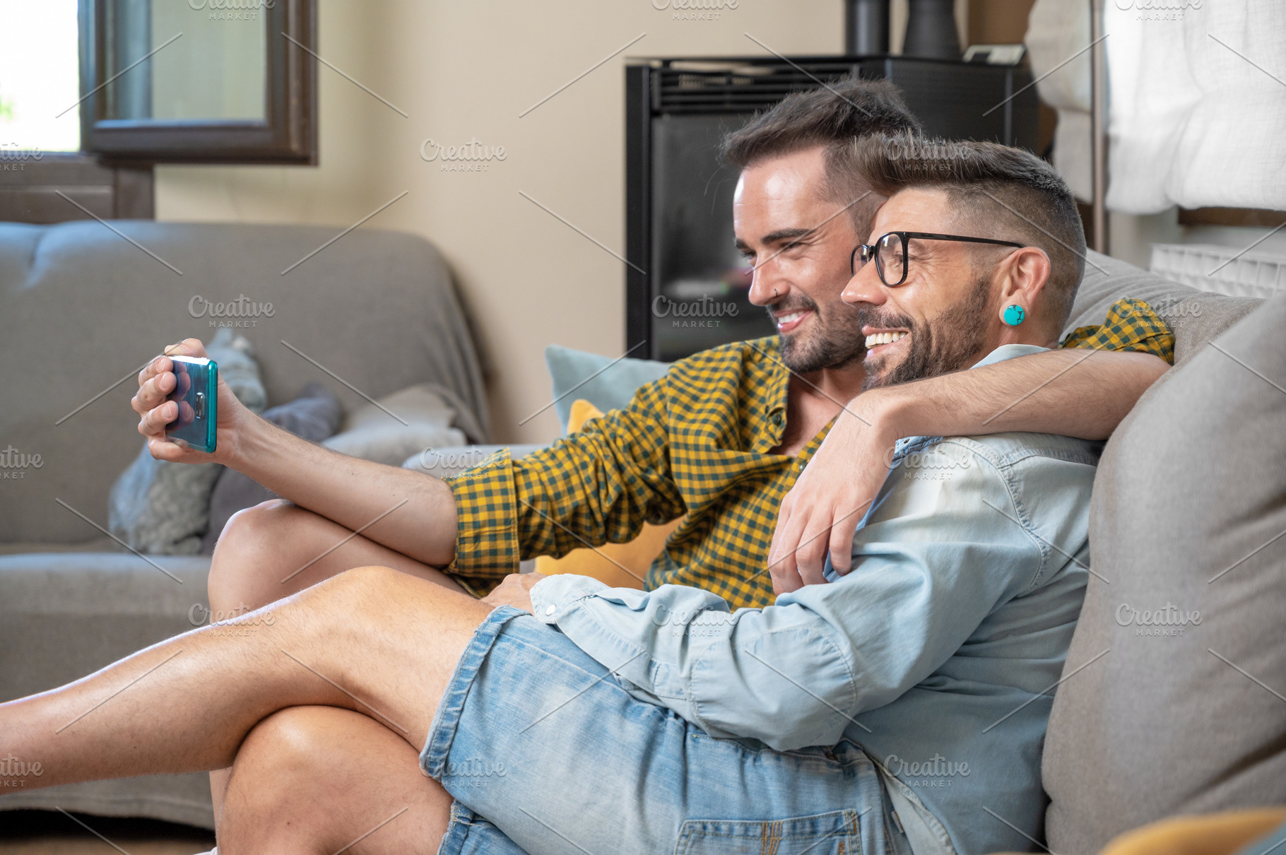 Young smiling gay couple taking selfie at home., a Person Photo by david.herraez.calzad