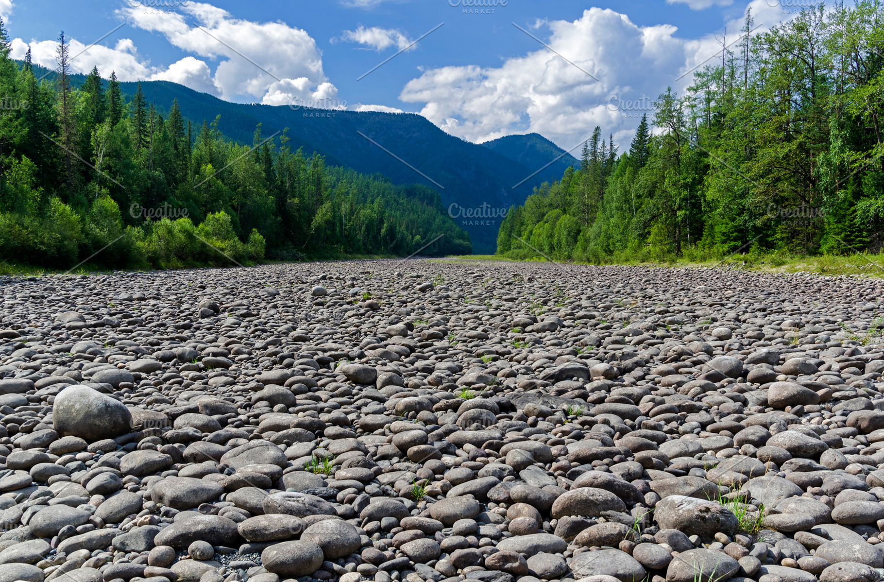Dry stony river bed containing cloud, serene, and sky, a Nature Photo by possum