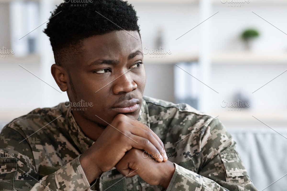 Unhappy military black man standing next to window, a Photo by Prostock-Studio (Photo 4 of 7)