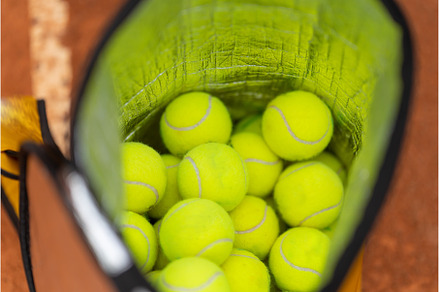 A basket filled with yellow tennis, a Sports & Recreation Photo by Barcelona_dreams