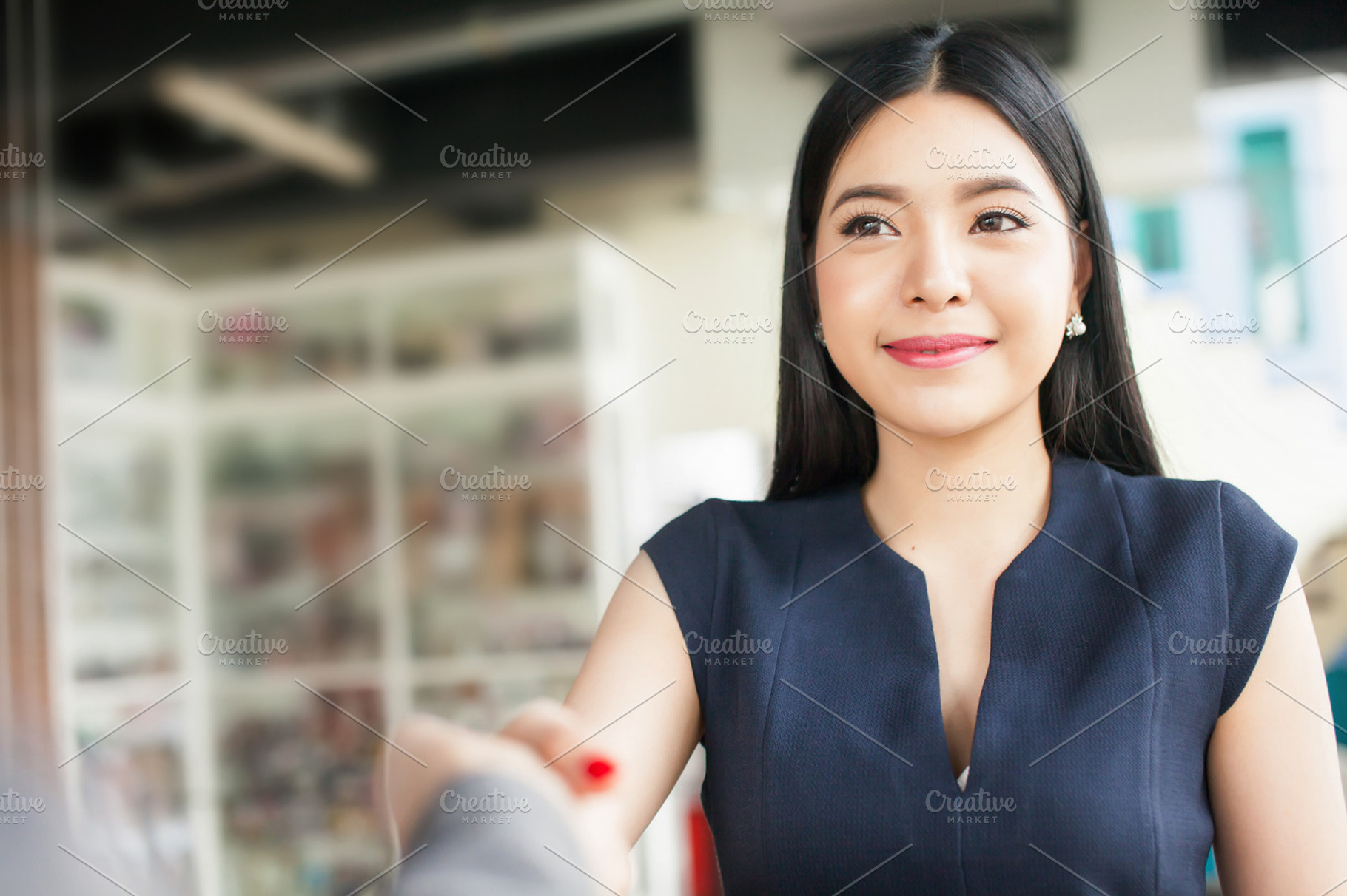 Confident Asian businesswoman smiling and shaking hands, a Business Photo by Twinster Photo