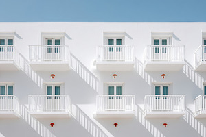 Modern white building with balconies, an Architecture Photo by AlyaAnd