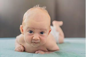 One-month-old baby lying on tummy, a Person Photo by Elizaveta Galitskaya