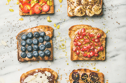 Vegan toasts with fruit, seeds, nuts, a Food & Drink Photo by Foxys