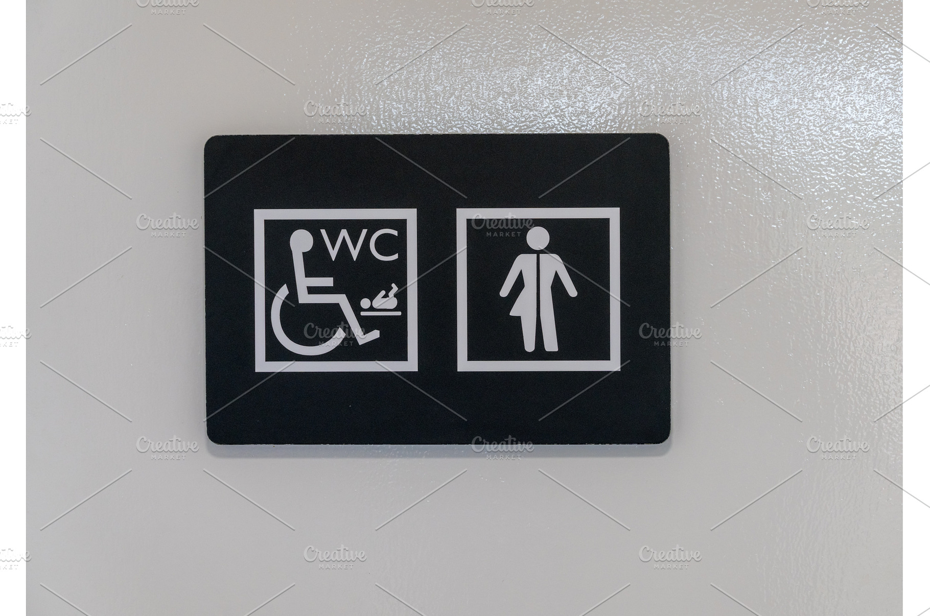 Sign to toilets in England on white, an Architecture Photo by Backyard Stock