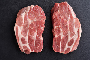 Fresh raw pork shoulder butt slices containing pork, meat, and shoulder