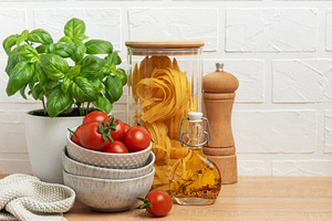 Cherry tomatoes, basil, pasta and olive oil creating an italian, a Food & Drink Photo by Olena Rudo