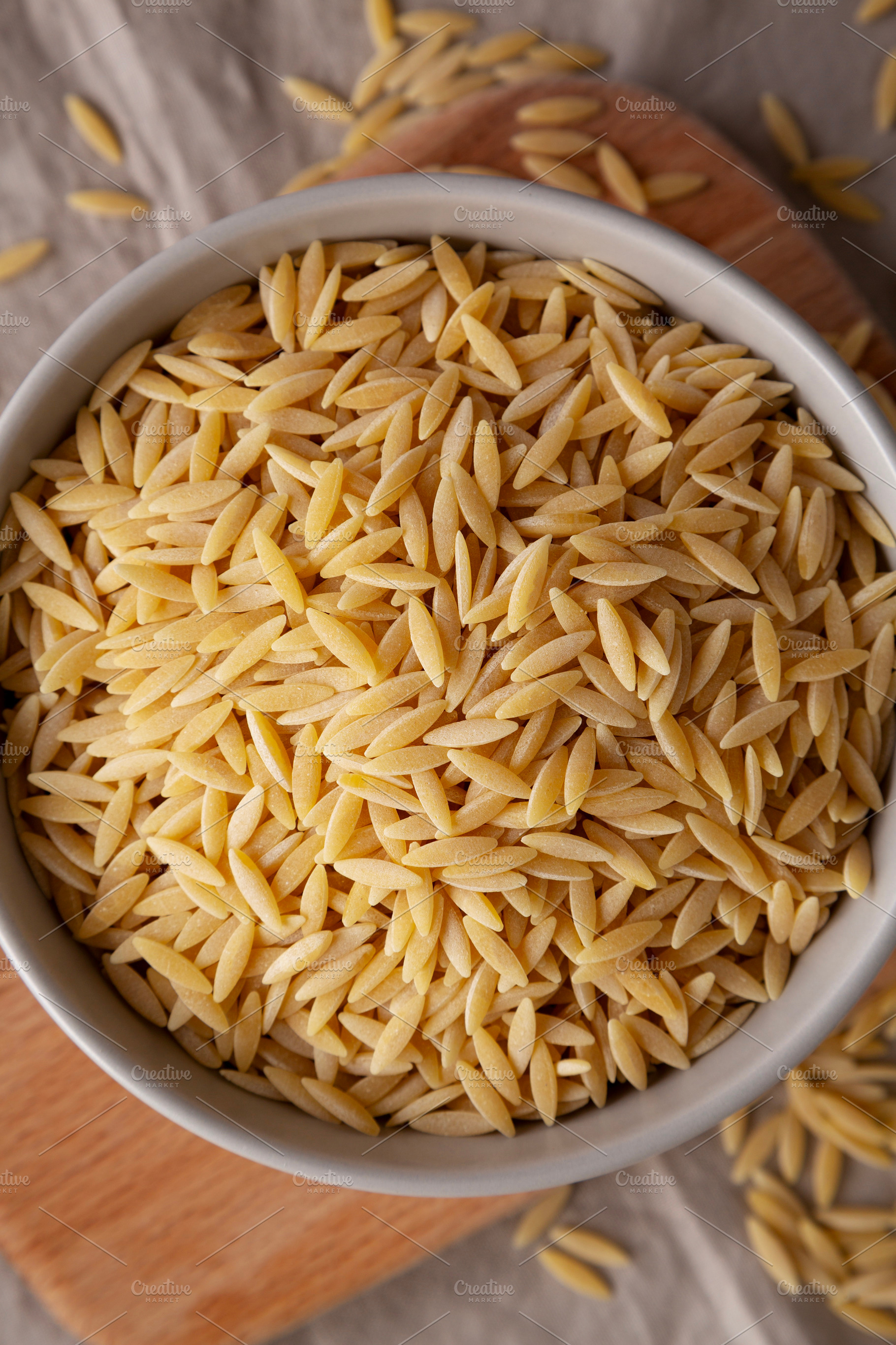 Organic Dried Orzo Pasta in a Bowl, top view., a Food & Drink Photo by LiudmylaChuhunova