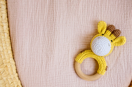 in a basket natural wooden knitted toys for a newborn. View from above