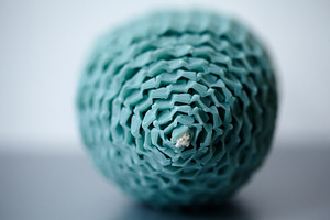 Extreme macro close-up of a teal beeswax egg-shaped candle texture and wick., a Holiday Photo by Rohan Photography