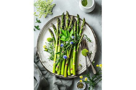 Green asparagus sprouts in plate, a Food & Drink Photo by Neirfy