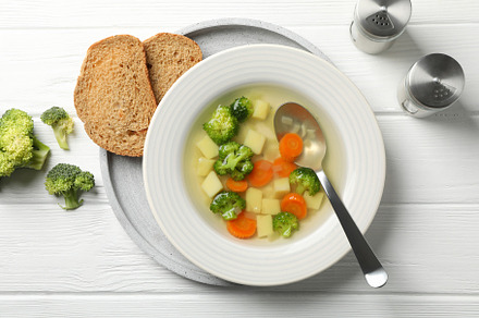 Soup on wooden background, top view. Healthy food, a Food & Drink Photo by AtlasStudio