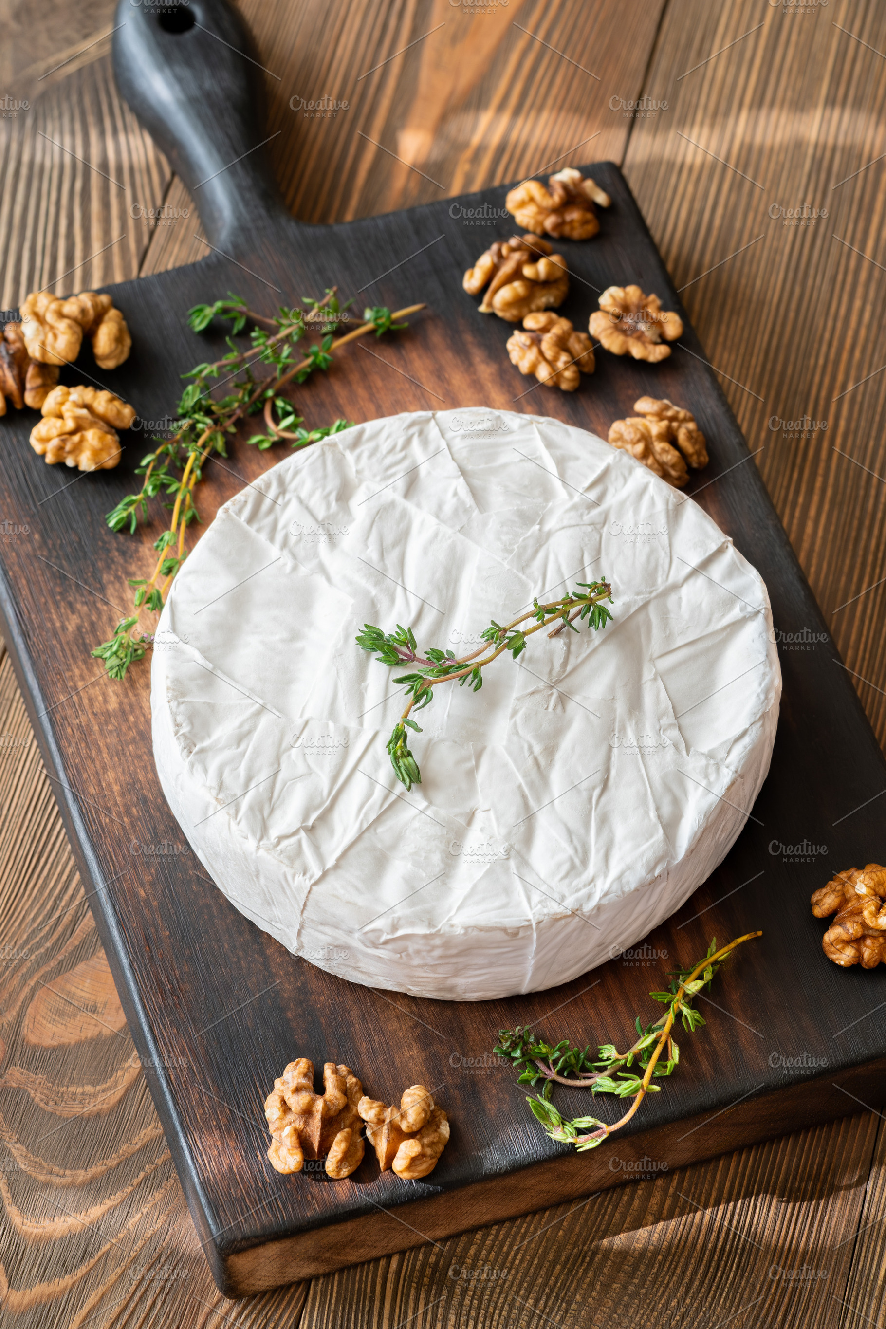 Camembert Cheese Garnished With Fresh Thyme And Walnuts Rustic G, a Food & Drink Photo by Alexander Prokopenko