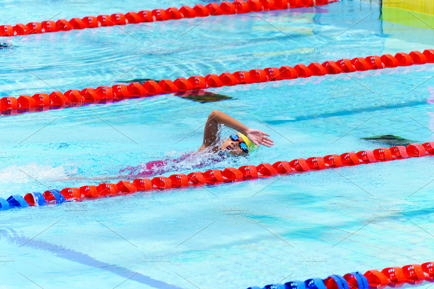 Swimmer child swims freestyle swimming style in a race swimming, a Sports & Recreation Photo by Casanowe-studio