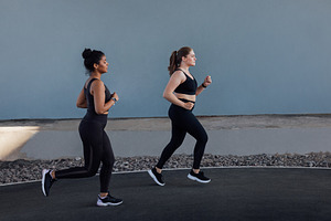Female friends running outdoors, a Sports & Recreation Photo by Artem Varnitsin