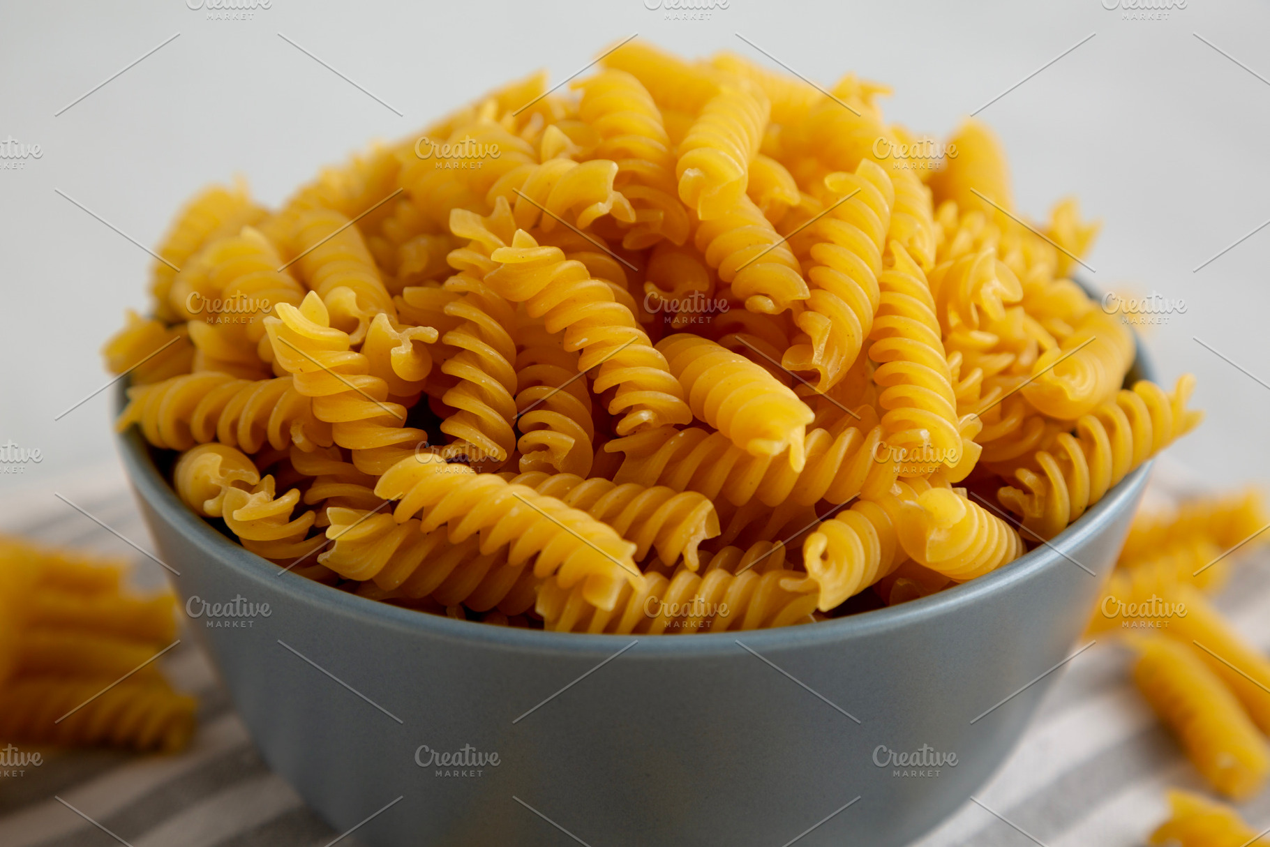 Dry Fusilli Pasta in a Bowl, low angle view. Close-up., a Food & Drink Photo by LiudmylaChuhunova