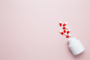 White bottle container with colorful medication capsules and tablets. Concept o, a Photo by matucha