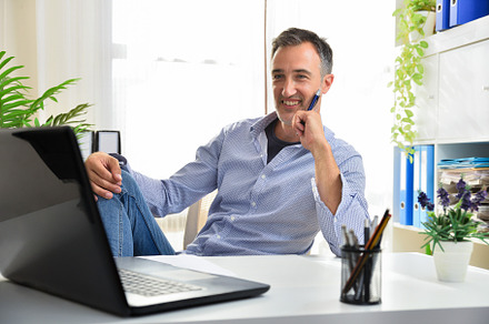 Entrepreneurial adult man sitting comfortably proudly at his des, a Business Photo by Davizro's Market