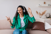 Happy Lady Wearing Earphones Listening To Music Having Fun Indoor, a Photo by Prostock-Studio (Thumbnail 3 of 3)