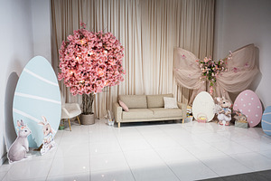 Easter themed living room setup with decorated eggs and festive bunny decoratio, a Photo by AS photostudio