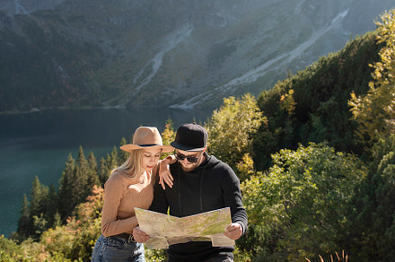 Young tourist couple, man and woman, on hiking path in mountains, a Person Photo by Olena Rudo
