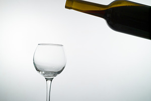 Red wine pouring into a wine glass containing wine, red, and drink