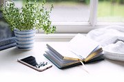 Phone and book at window, a Business Photo by the studio louvain shop (Thumbnail 2 of 2)