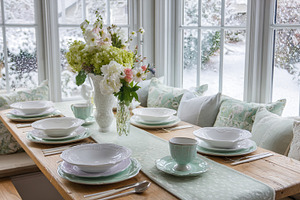 Cozy dining room table set for a meal, showcasing elegant dishwa, a Photo by Studio ANNA