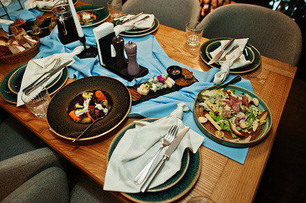 Beautifully laid tables with food, glasses and appliances in res, a Food & Drink Photo by AS photostudio