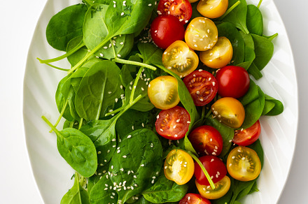 Salad with tomatoes and spinach, a Food & Drink Photo by Pandateam