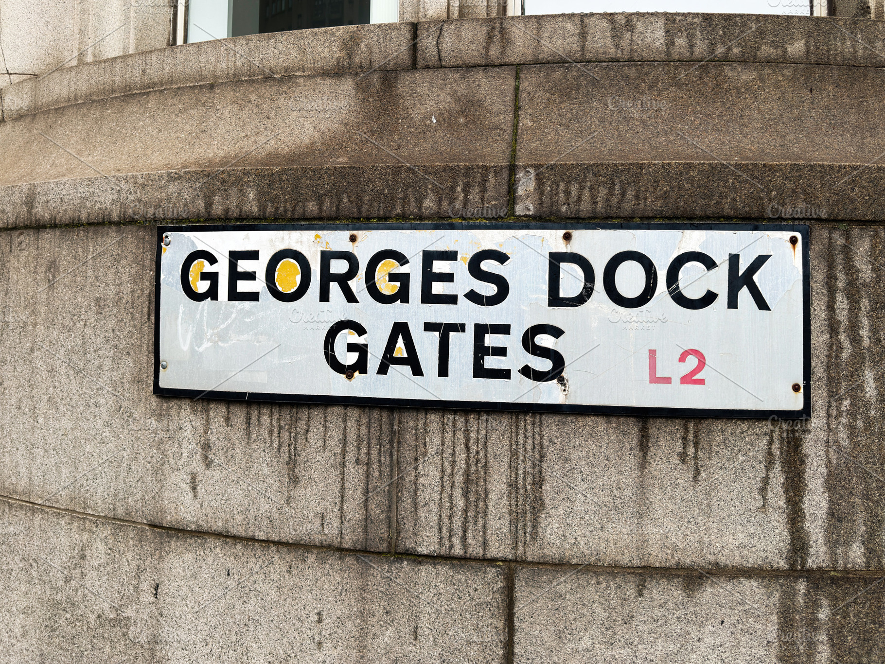 Georges Dock Gates street sign on a weathered stone building in, a Photo by AS photostudio