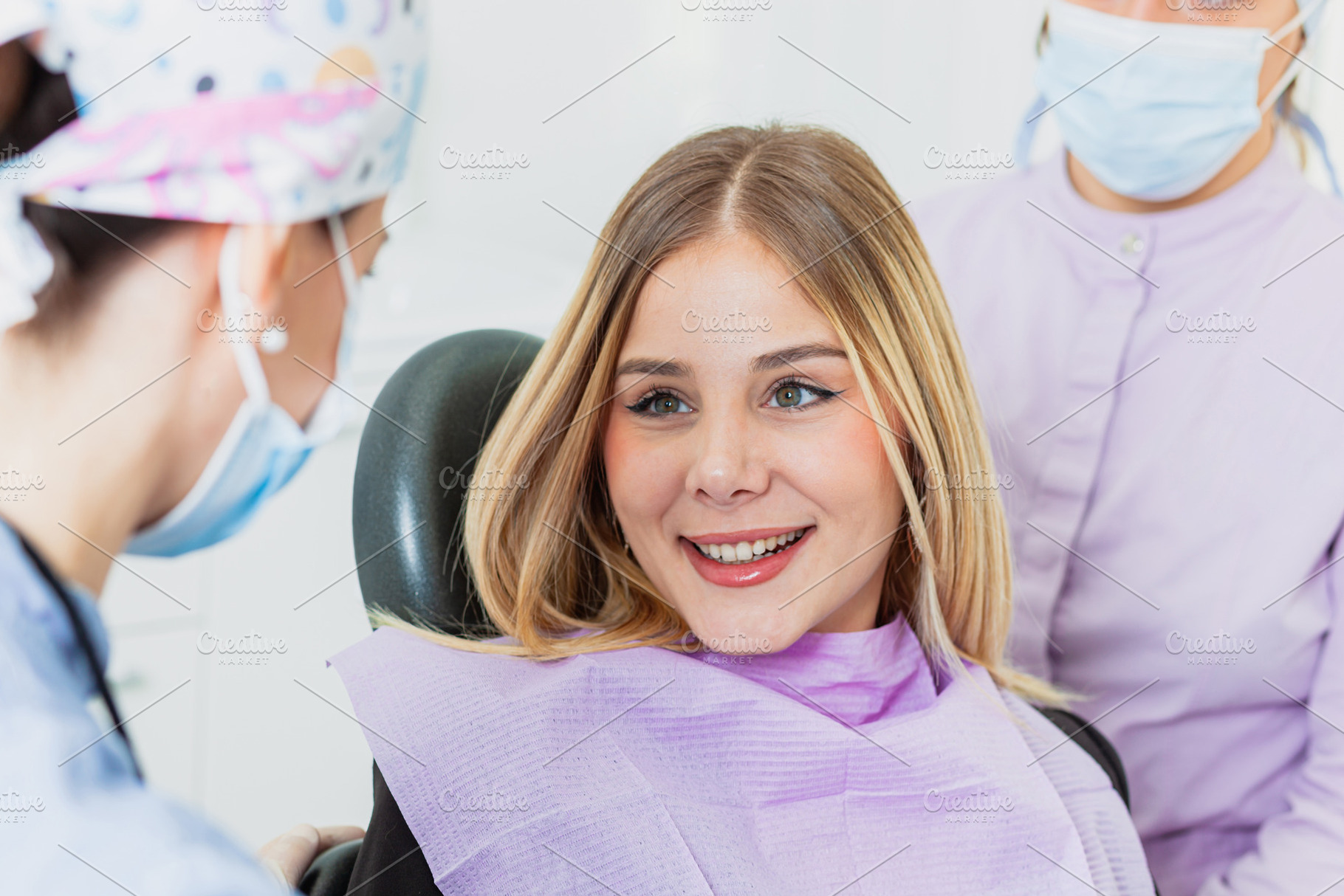 Young woman smiling during dental checkup with her dentist, a Health & Medical Photo by Antonio Gravante Market