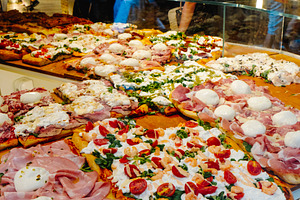 assorted pizza al taglio in an italian pizza shop, a Photo by Nito