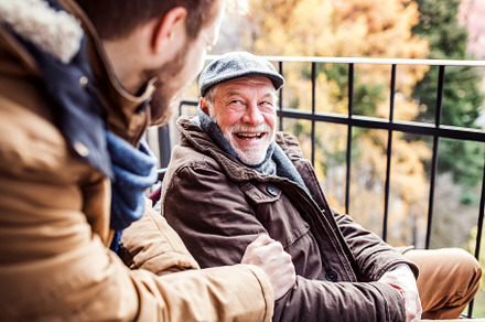 Senior father in wheelchair and young son on a walk containing adult, male, a Person Photo by HalfPoint