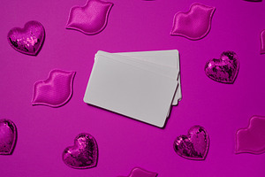 Set of blank white business cards surrounded by pink decorative, a Holiday Photo by ndanko