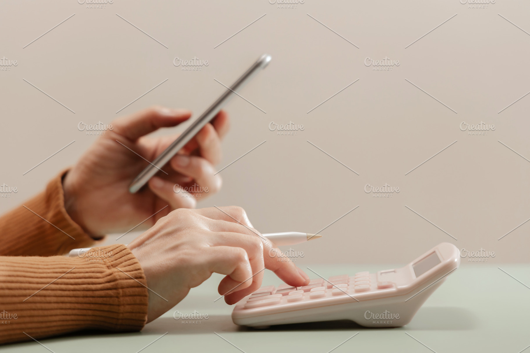 Person using calculator and smartphone together, representing pe, a Photo by salmon.black