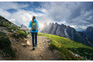 Female hiker walking on mountain, a Person Photo by den-belitsky
