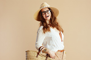 smiling elegant woman in blouse and shorts on beige, a Person Photo by Alliance Images