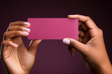 Female hands holding a magenta blank business card, close-up sho, a Business Photo by AS photostudio