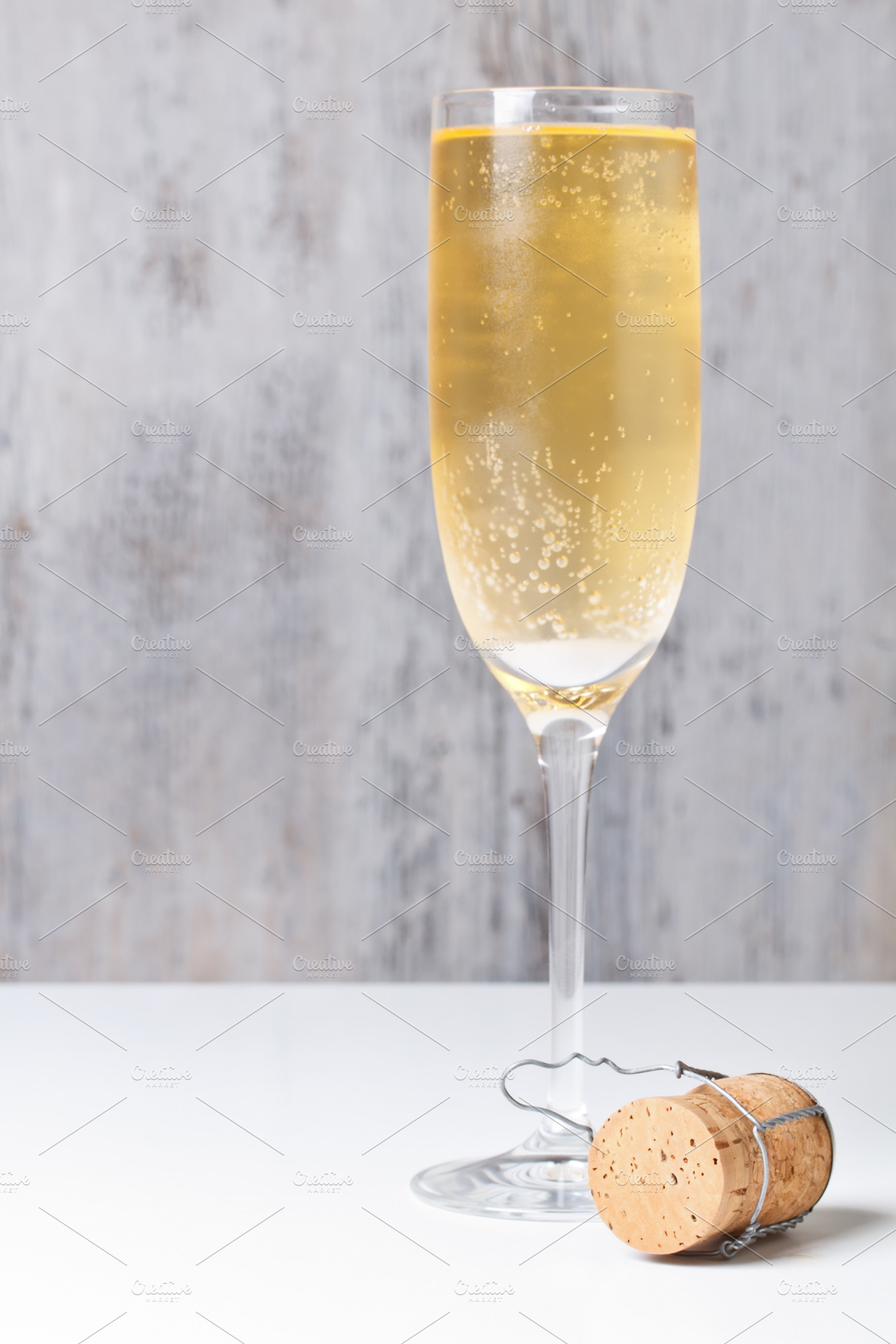 Champagne glass and cork containing alcohol, beverage, and celebrate