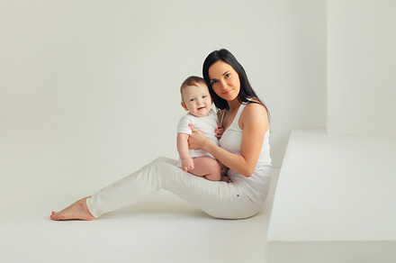 Happy young mother holding cute baby, a Person Photo by Rohappy