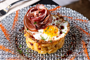 Traditional Spanish potato omelette with Iberian ham and crispy pork rind serve, a Food & Drink Photo by etorres69