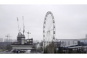 Ferris wheel rotating near, an Architecture Photo by Media Whale Stock
