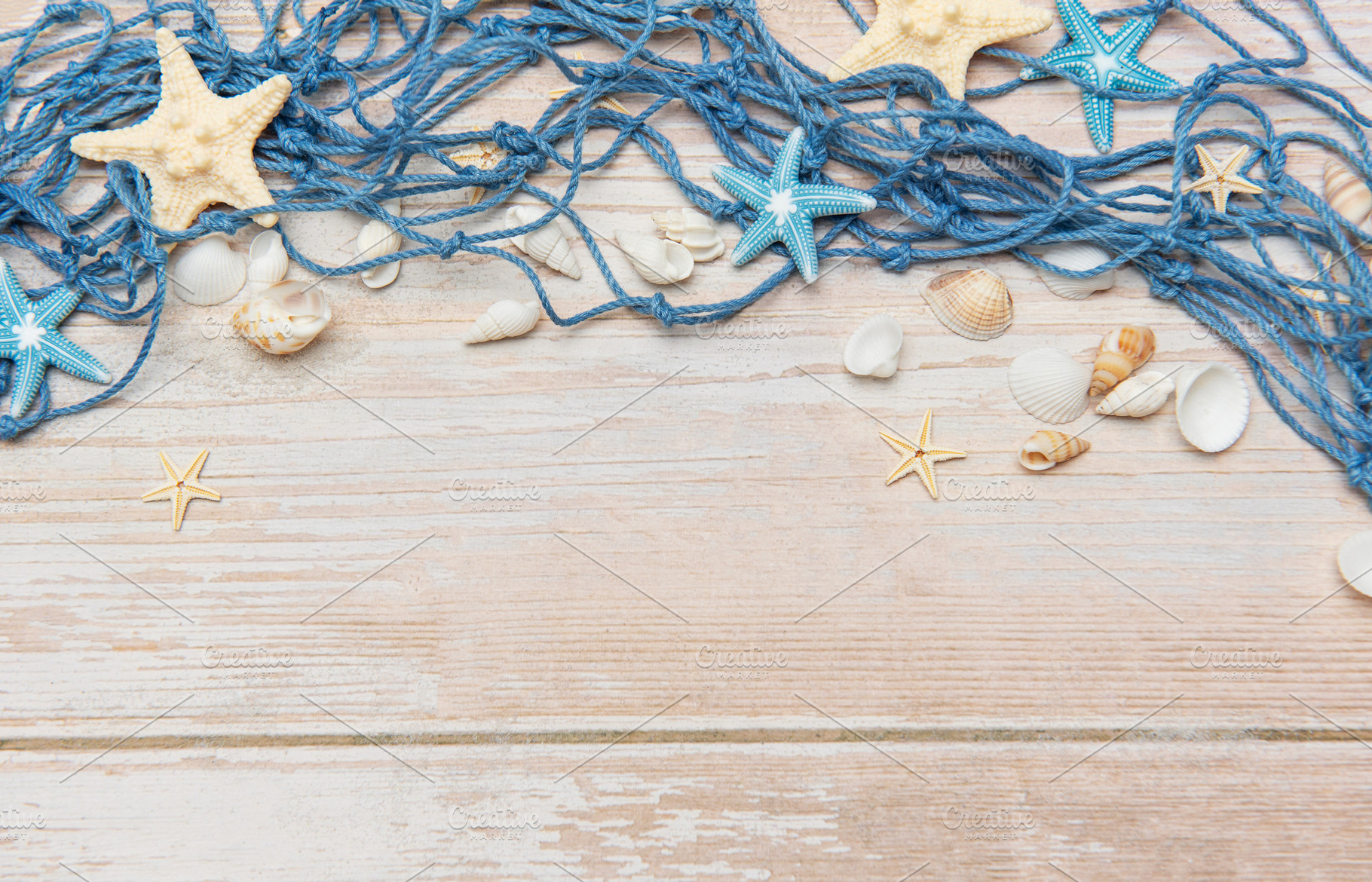 Fishing net, seashells, and starfishes creating a seaside border, a Holiday Photo by Olena Rudo